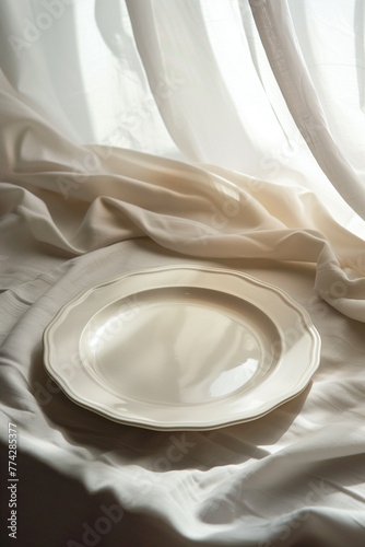 empty white plate on white fabric background © EvhKorn