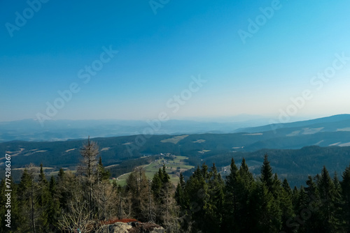Scenic view from massive rock formation Grossofen surrounded by idyllic forest in Modriach, Hebalm, Kor Alps, border Carinthia Styria, Austria. Refreshing hiking trail in remote Austrian Prealps