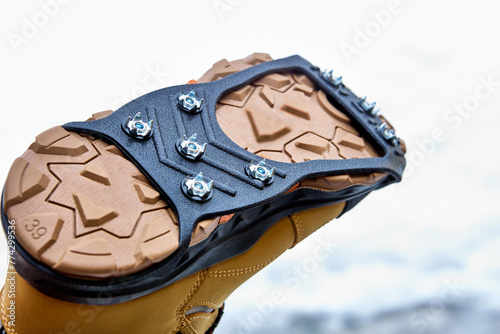 Ice traction cleats fit securely on any shoe or boot and allow you to stride easily on ice and snow-covered pavement and gravel. photo