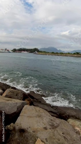 Wave smashing giant causeway stone in Ulee lheu Beach in Banda Aceh, Indonesia. Popular tourist destination in Aceh. photo