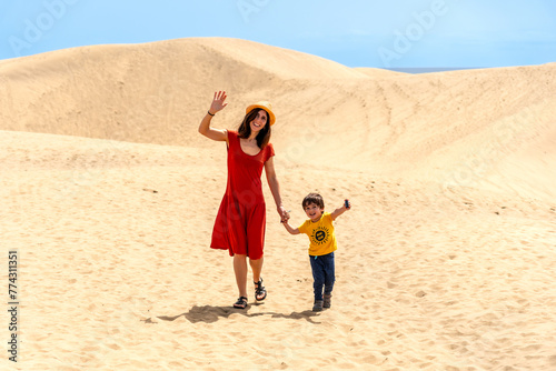 Mother and son tourists enjoying in the dunes of Maspalomas  Gran Canaria  Canary Islands
