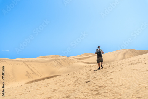 A man tourist enjoying in the dunes of Maspalomas, Gran Canaria, Canary Islands
