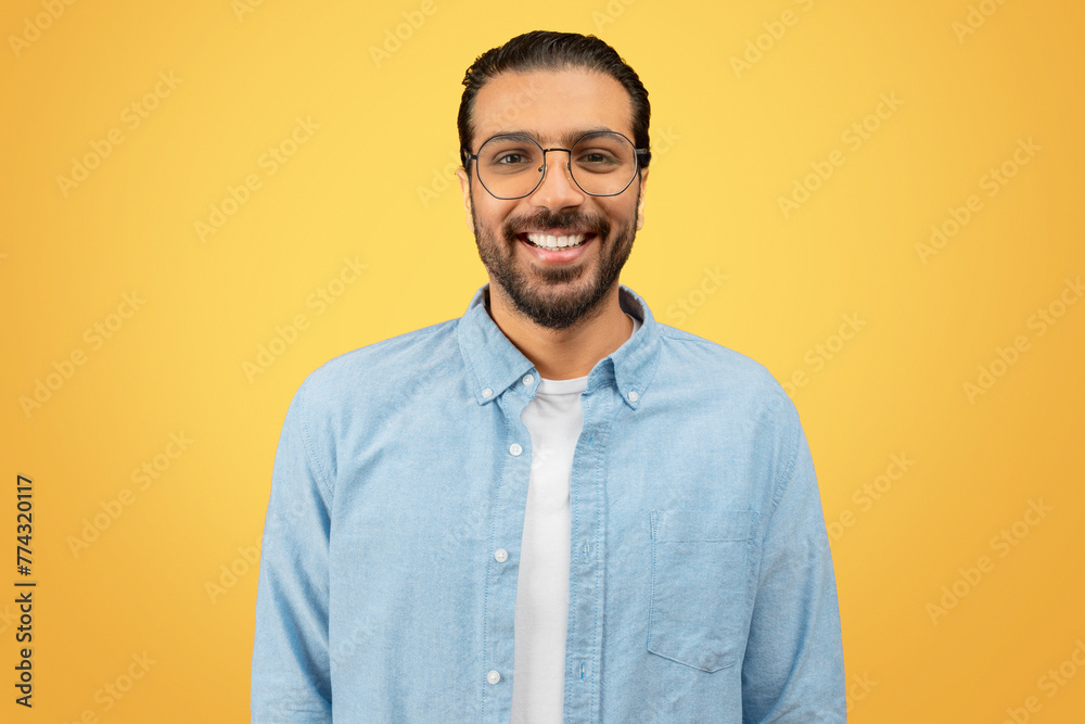 Smiling man with glasses on yellow background Smiling man with glasses on yellow background