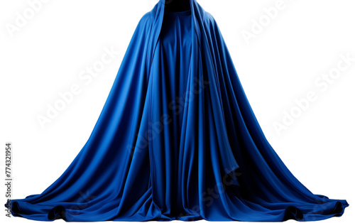 A woman with flowing blue dress and cape stands gracefully in a mystical setting photo