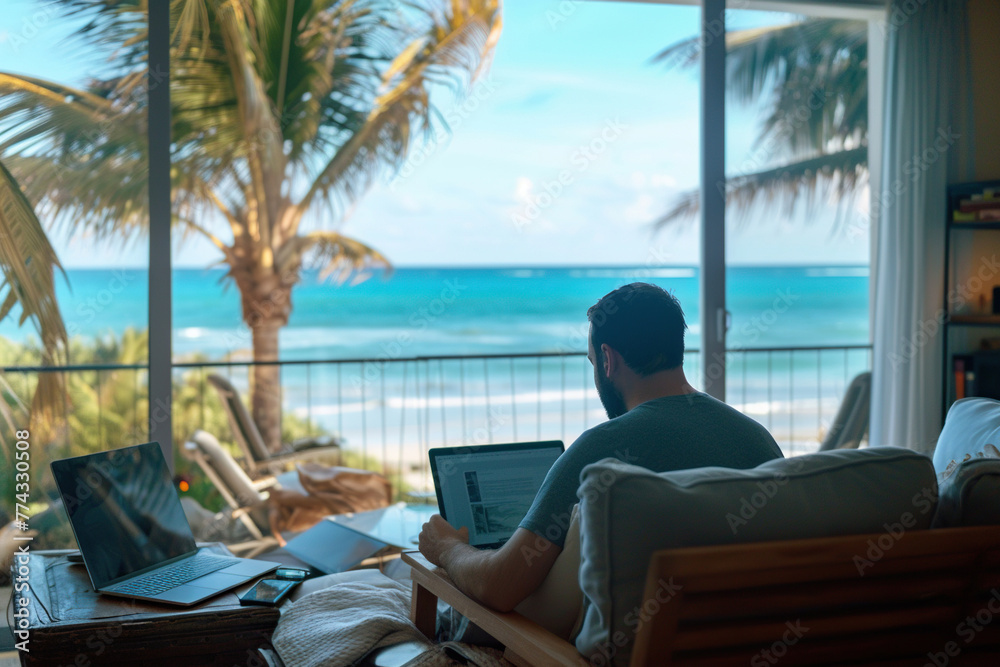a man working at a laptop against the backdrop of a tropical beach