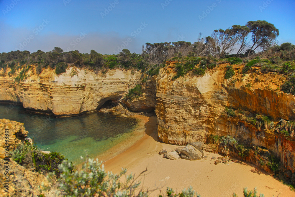 The morning fog hangs over a small bay and hidden beach along the southern coast of Victoria, Australia.