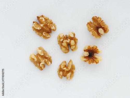 Shelled wallnuts scattered on white background