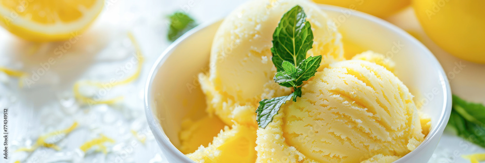 Fresh Lemon Ice Cream in White Bowl. This image showcases a refreshing bowl of lemon ice cream garnished with mint leaves, perfect for summer desserts. Fresh Lemon Ice Cream in White Bowl. This image showcases a refreshing bowl of lemon ice cream garnished with mint leaves, perfect for summer desserts.