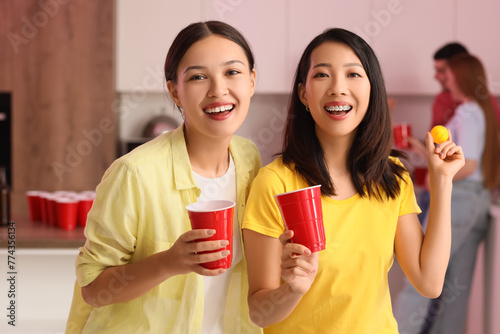 Female friends with cups an...