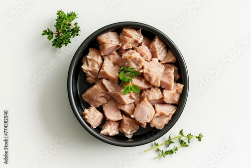 Canned pet food garnished with tyme top view white background photo