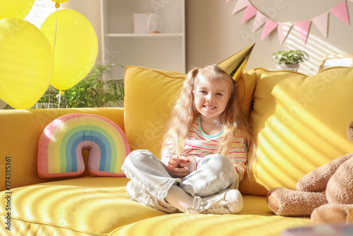 Cute little girl sitting on...