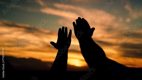 Man woman couple stretches their hands up to sun. Adventures, travel. Prayer sunset, faith in God, Man and woman raise their hands to sunny sky. Religion and faith teamwork. Group of friends, teamwork