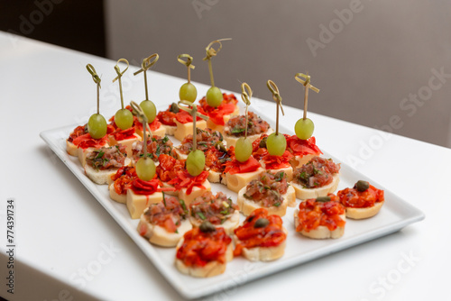 Plate with various seafood and meat canapes.