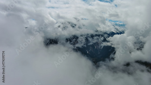 Aerial view of snowcapped mountains in clouds © Kokhanchikov