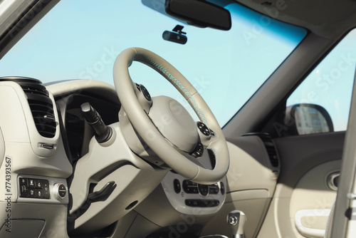 Black steering wheel and dashboard in modern car © New Africa