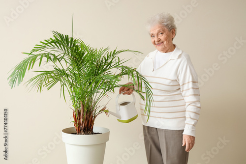 Senior gardener watering pa...