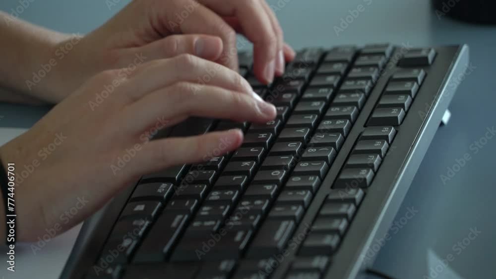 woman's hands of a female office worker typing on a computer keyboard in the office