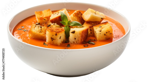 A white bowl overflowing with steaming soup and crunchy croutons