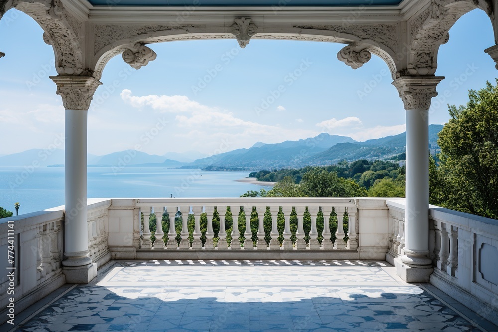 View from a beautiful white balcony with columned arches and a balustrade to the sea coast and a beautiful landscape under a cloudy blue sky