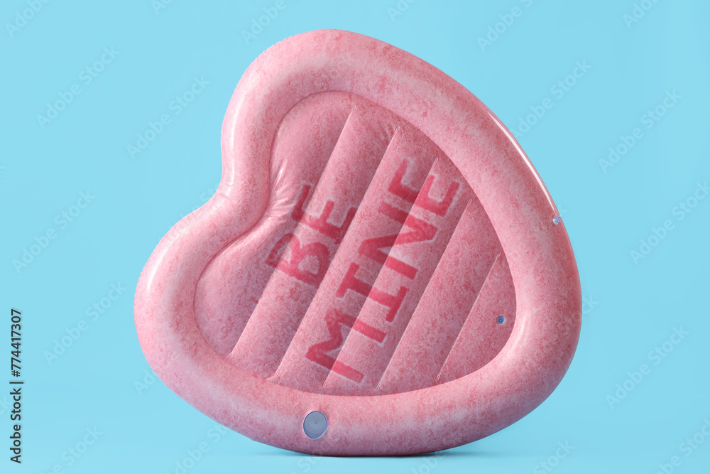 Swimming mattress in shape of heart on blue background Swimming mattress in shape of heart on blue background