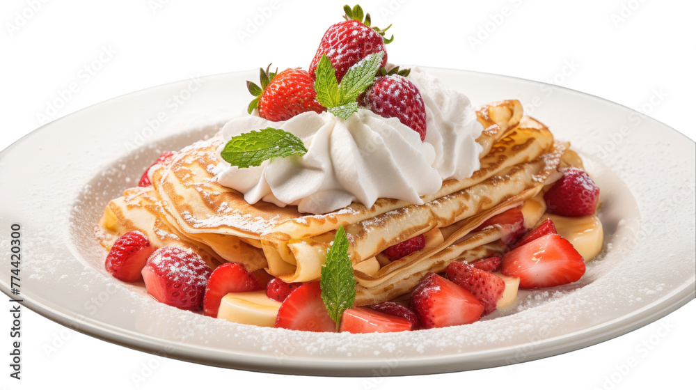 A white plate holds waffles, topped with whipped cream and strawberries