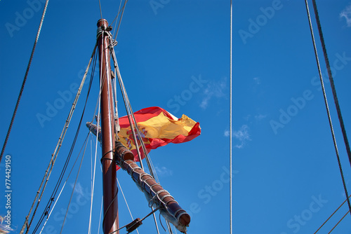 Bild auf Leinwand The Spanish flag on a mast of a sailboat