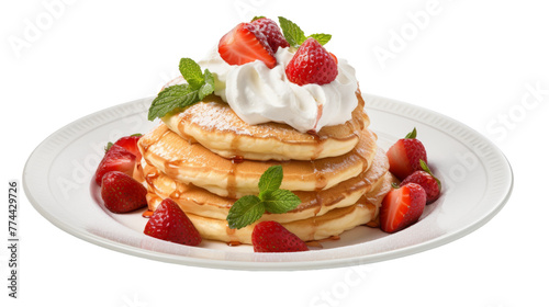 A luxurious stack of pancakes topped with billowy whipped cream and fresh red strawberries