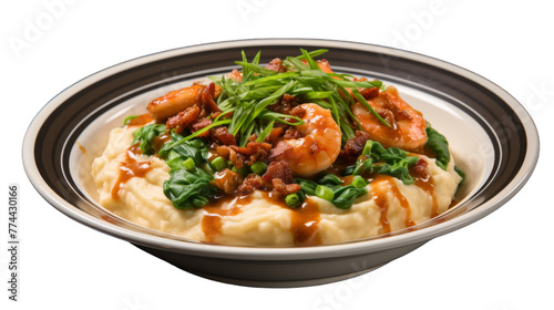 A bowl with fluffy mashed potatoes, juicy shrimp, and vibrant greens on top
