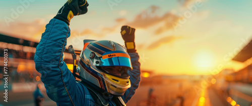 Triumphant racer exults in pit box win with helmet on at sundown photo