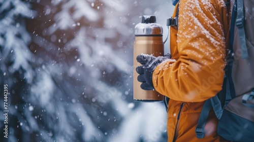 Portrait man in yellow jacket holding insulated drink container on cold winter season. AI generated