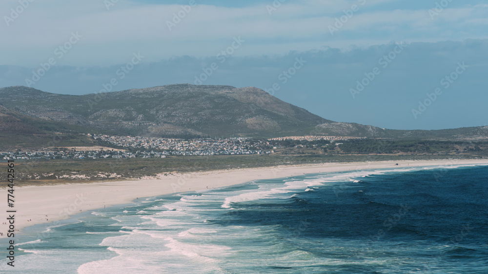 Serene Noordhoek Beach in South Africa With Pristine White Sands and Gentle Waves at Dusk