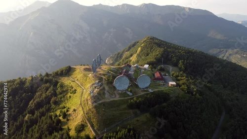Aerial view of the big parabolic antenna of the NATO radio station abandoned on the top of Monte Giogo, used during cold war. Comano, Massa and Carrara province, Lagastrello lake, Tuscany, Italy.  photo