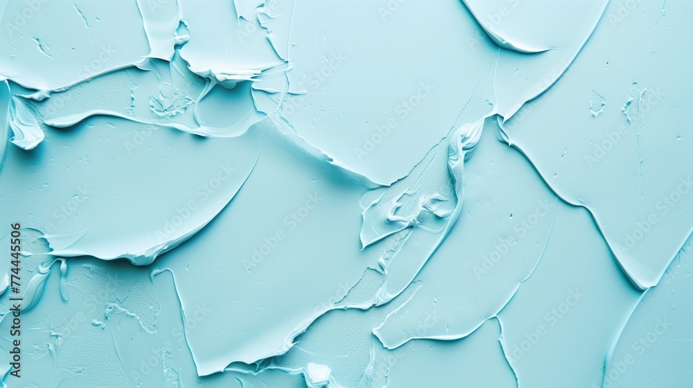 Close-up view of a cracked light blue surface with peeling paint texture