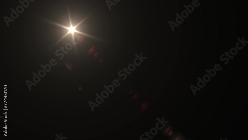 Optical Lens flare effect on black background. Movement of the sun across the sky. Anamorphic lens effect in yellow tone, 4K video. Overlay light effect animation.