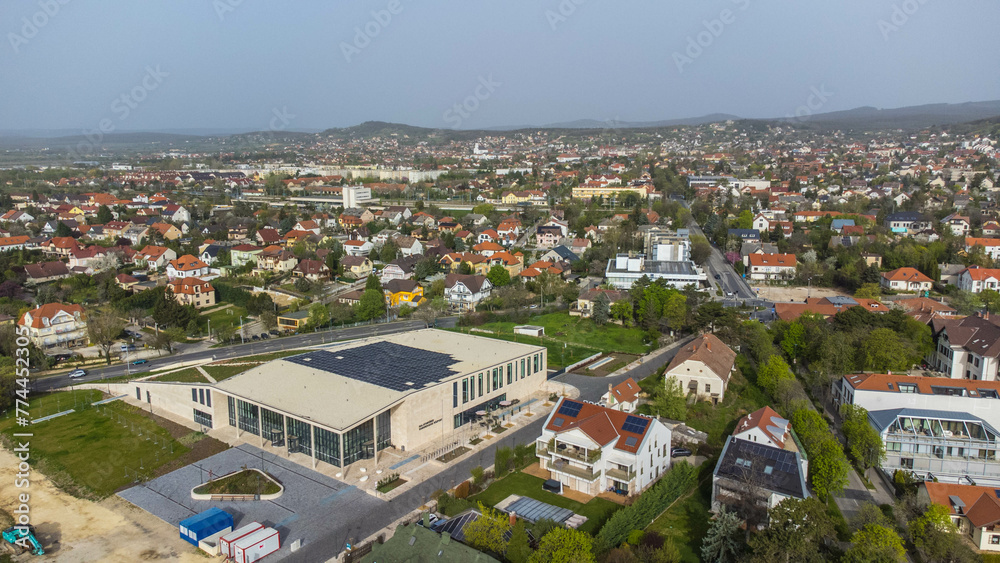 Balatonfüred Kongresszusi Központ, located in Balatonfüred, Hungary, is a modern congress and event center nestled in the heart of the resort town captured from a drone