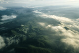an aerial view of a foggy morning over a forest or mountain