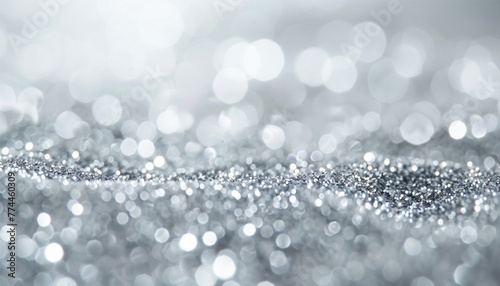 Silver glitter sparkles on a white background, Silver and white bokeh lights defocused. abstract texture background.