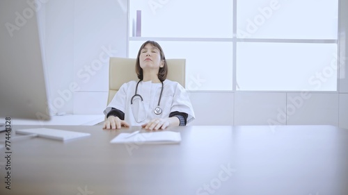 Doctor relaxing at office desk