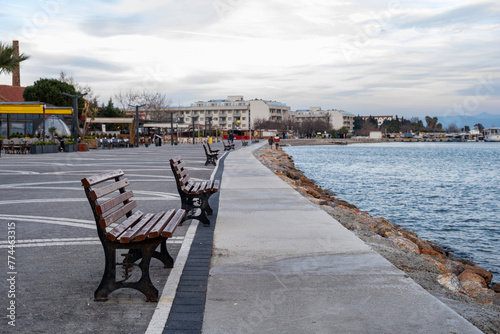 Benches on the embankment of the aegean Sea in Turkey. Walking road adn benches by the sea on Seaside town © Caneritir