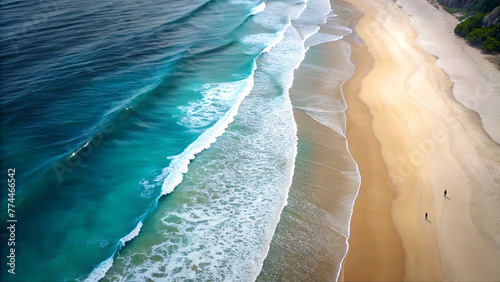 Waves crashing on the sandy beach under the bright blue sky, a picturesque scene of coastal beauty