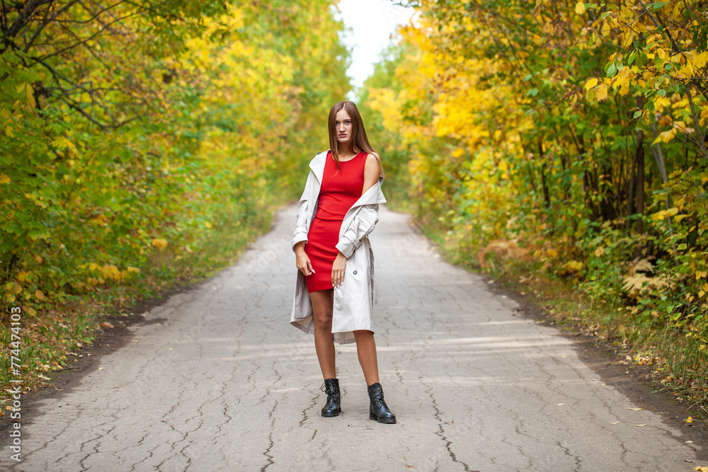 Fashion portrait of a young beautiful woman in red dress