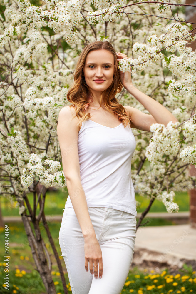 Young beautiful woman in a blooming garden Young beautiful woman in a blooming garden