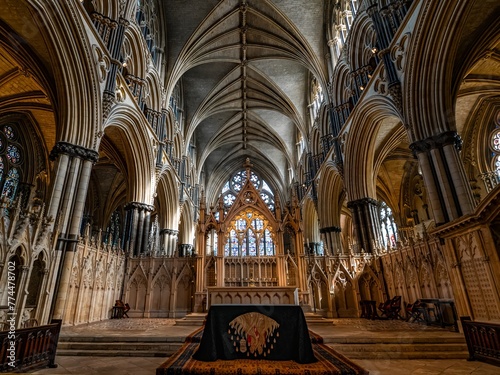 Lincoln Cathedral, Roman Catholic Gothic church and cathedral with stain glass window corridor and hall, with arches, columns, pews, vault, aisles, gallery, arcades and clerestory. photo