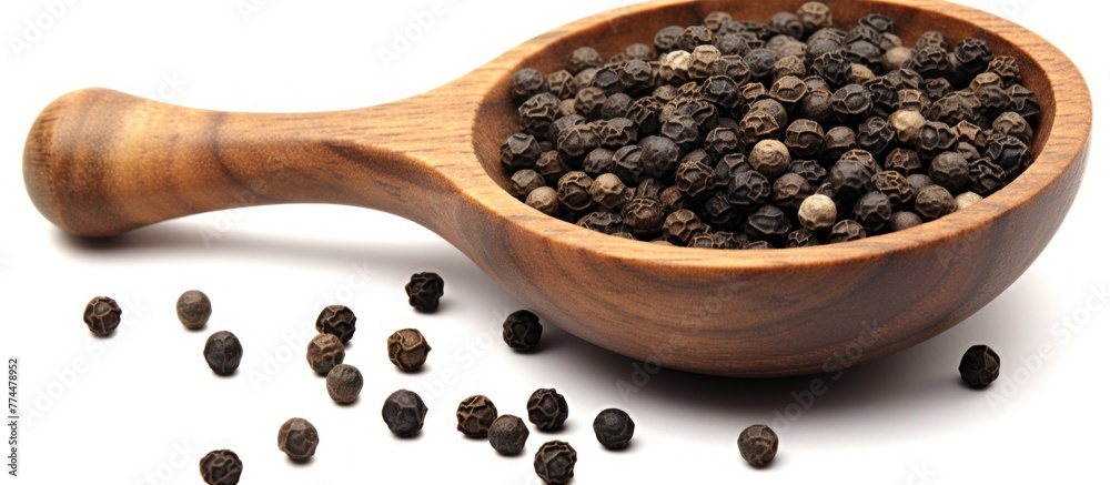 Close up black pepper seeds or peppercorns ( dried seeds of piper nigrum) in wooden bowl and spoon isolated on white background Close up black pepper seeds or peppercorns ( dried seeds of piper nigrum) in wooden bowl and spoon isolated on white background