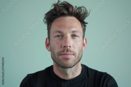 Portrait of a man with freckles on his face looking at the camera