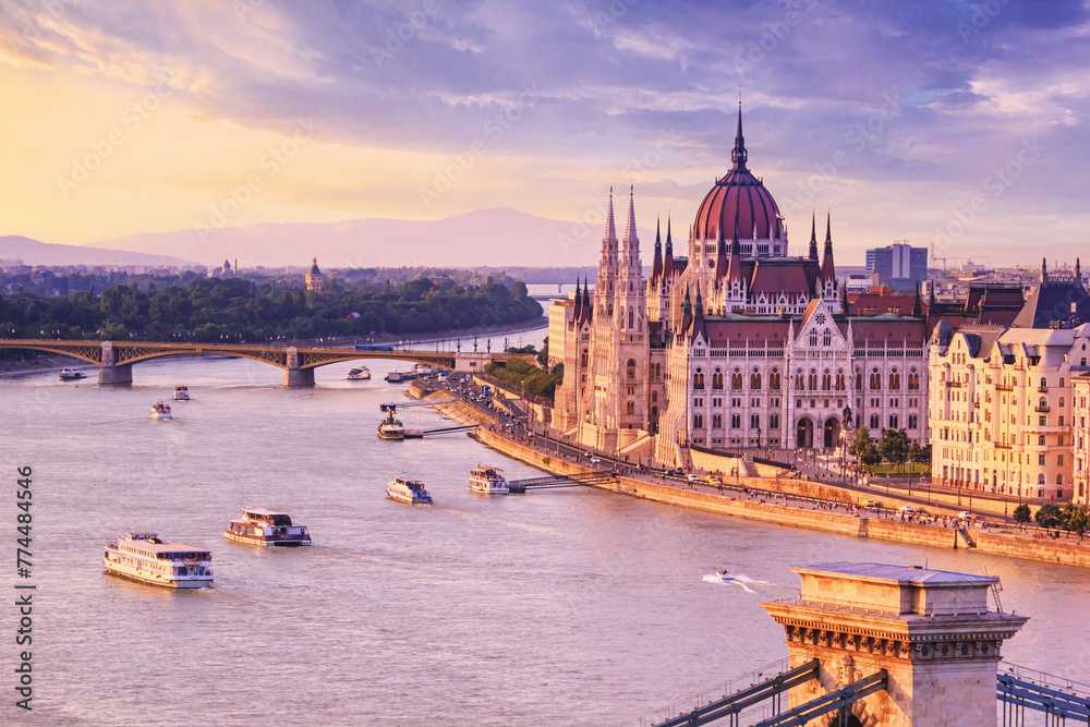 Fototapeta premium City summer landscape at sunset - view of the Hungarian Parliament Building and Danube river in the historical center of Budapest, Hungary