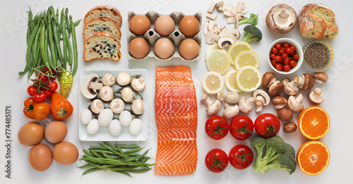 assortment of superfoods for a balanced diet - healthy eating flat lay with fresh vegetables, fruits, legumes, nuts, fish and eggs