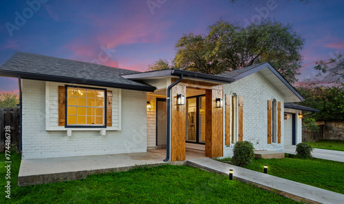 Fotografija a newly remodeled house with a path