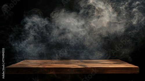 On a black background, an empty wooden table with smoke floats up. Empty space for displaying your products, © chanidapa