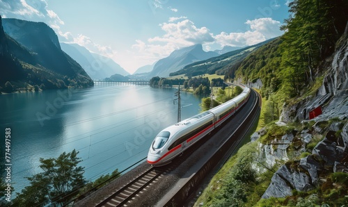 High-speed train driving through a beautiful landscape with a river and a forest - preserving nature with sustainable transportation photo